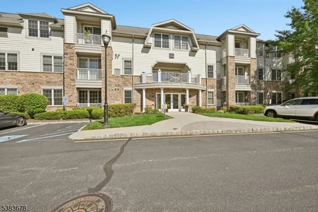 a front view of residential houses and street with trees