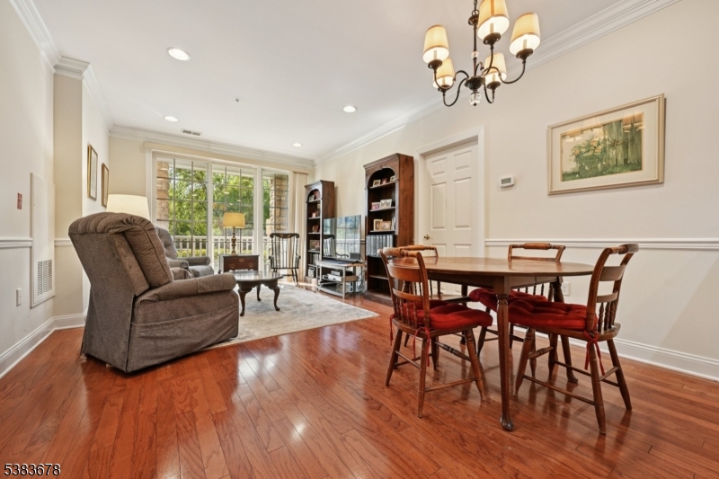 252 Victoria Drive, Unit 252 Bridgewater, NJ 08807 - Photo 3 of 26 a view of a dining room with furniture window and wooden floor