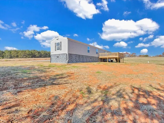 a view of a large pool with an outdoor space and seating area