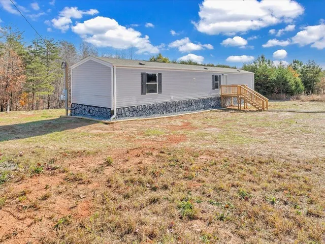 a view of a house with a yard and garage