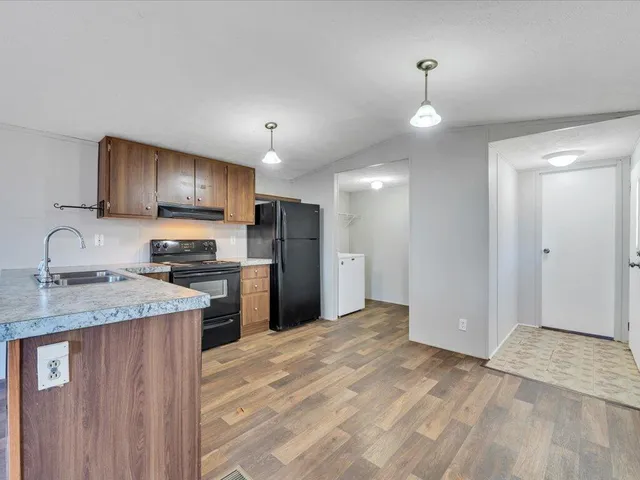 a kitchen with refrigerator cabinets and a sink