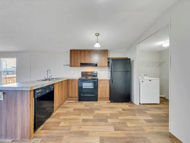 a kitchen with a refrigerator and a sink