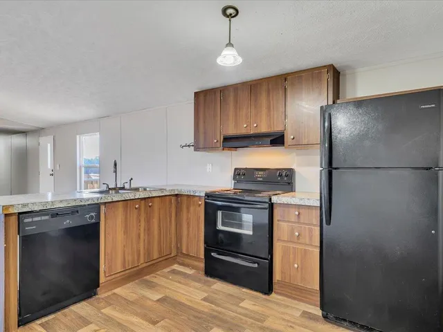a kitchen with a sink stove and refrigerator