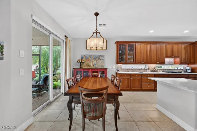a dining room with a sink a counter top space and living room view
