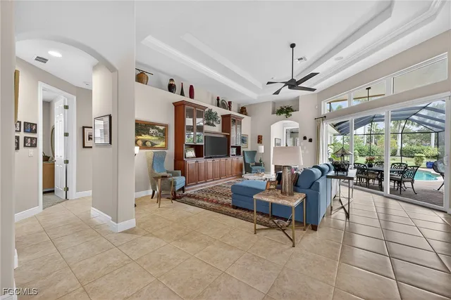 a living room with furniture and large windows