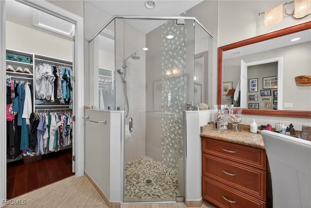 a bathroom with a shower sink and mirror