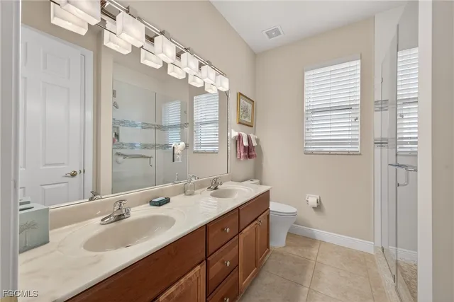 a bathroom with a sink double vanity and a mirror