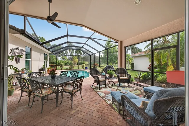 a view of a patio with a table chairs and a backyard