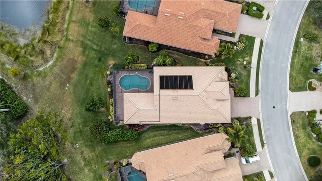 an aerial view of a house with a yard