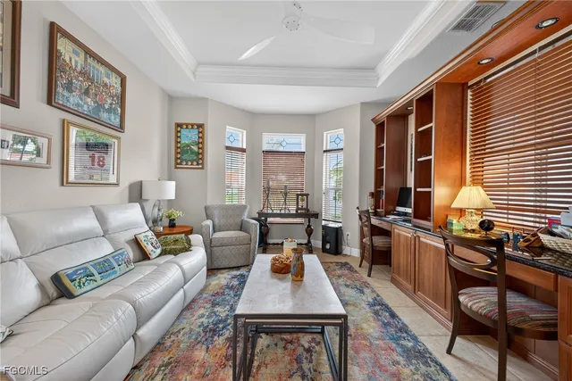 a living room with furniture large windows and wooden floor
