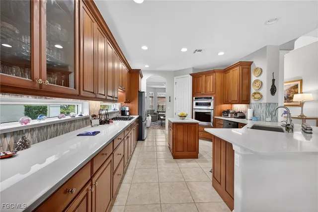 a kitchen with stainless steel appliances a sink counter space cabinets and a counter top space