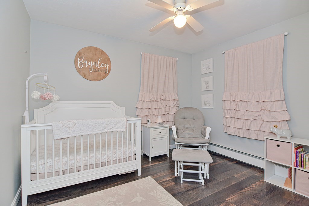 20 Prouty Lane Rutland, MA 01543 - Photo 28 of 40 a bedroom with a baby bed a chandelier and chair