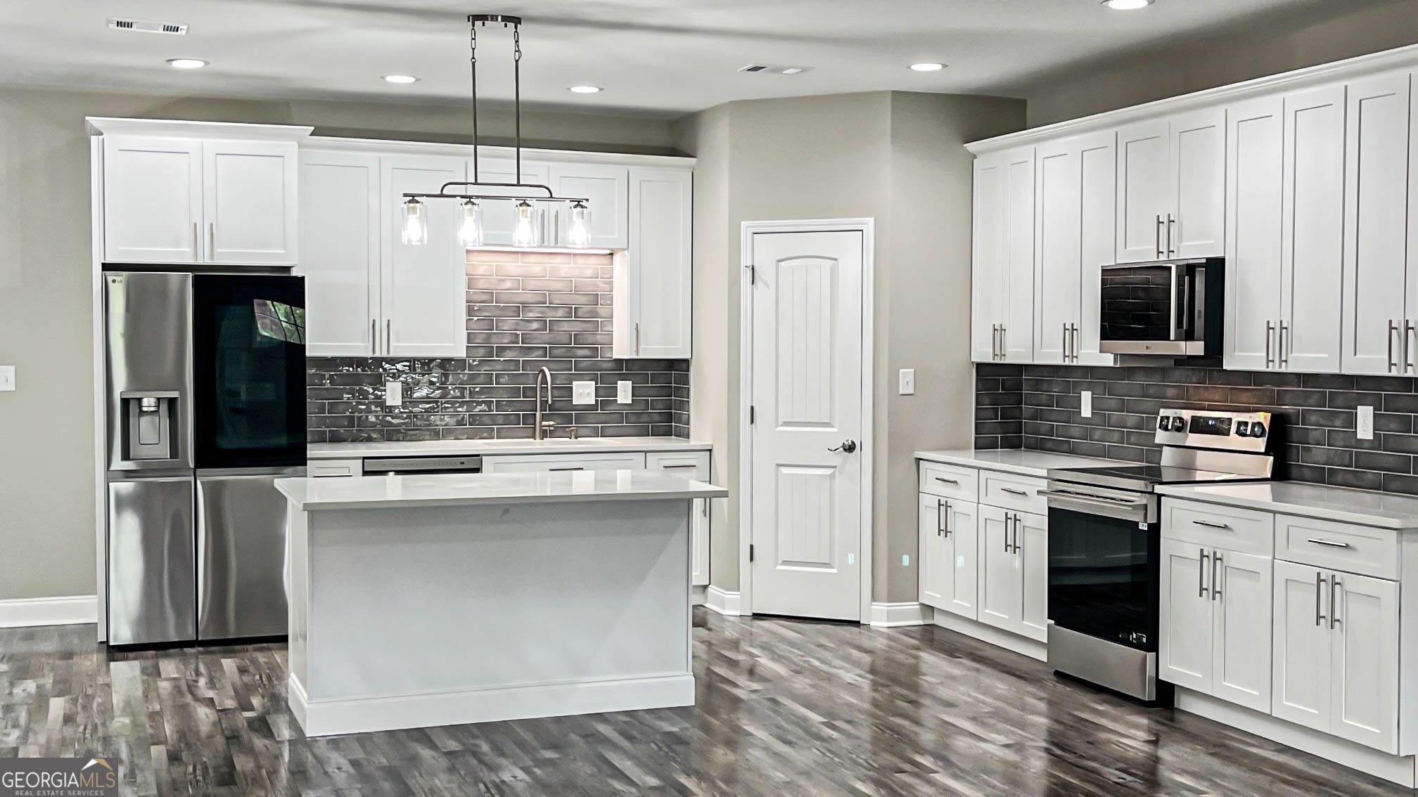 2011 Griffin Road Macon, GA 31216 - Photo 14 of 64 a kitchen with stainless steel appliances a stove refrigerator sink and microwave