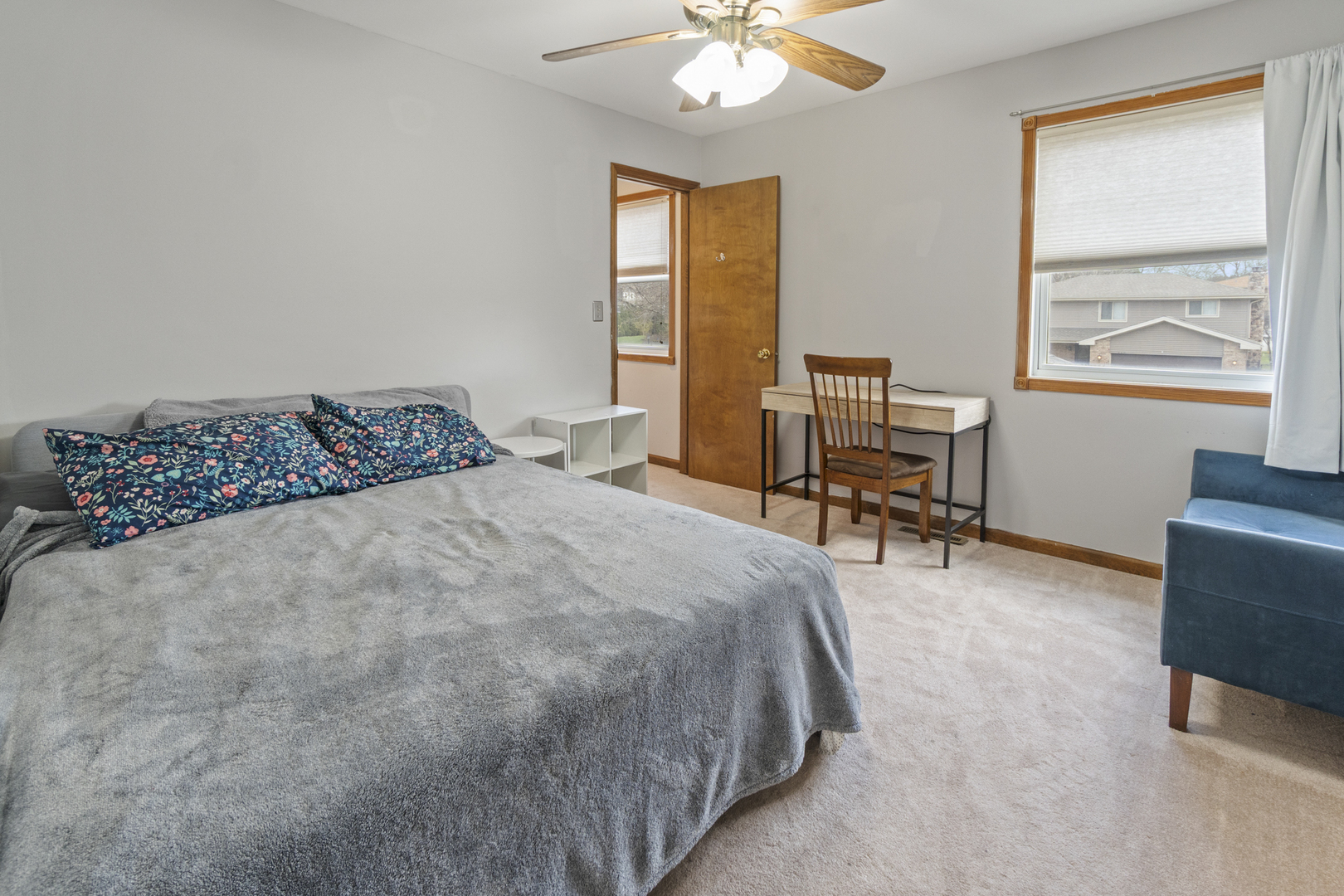 946 Pin Oak Circle Cary, IL 60013 - Photo 15 of 35 a bedroom with a bed table chair and two windows