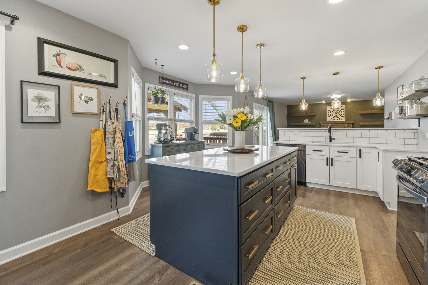 946 Pin Oak Circle Cary, IL 60013 - Photo 3 of 35 a kitchen with stainless steel appliances granite countertop a sink counter space and wooden floor