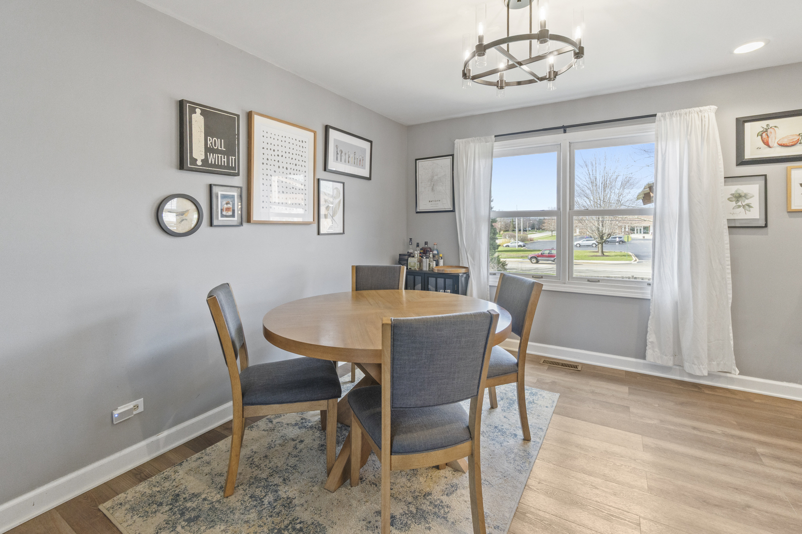 946 Pin Oak Circle Cary, IL 60013 - Photo 9 of 35 a view of a dining room with furniture window and wooden floor