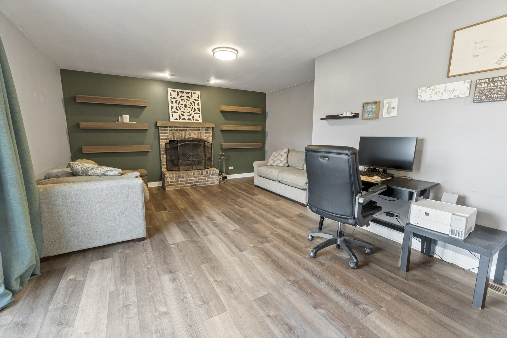 946 Pin Oak Circle Cary, IL 60013 - Photo 10 of 35 a view of a workspace with furniture and a flat screen tv