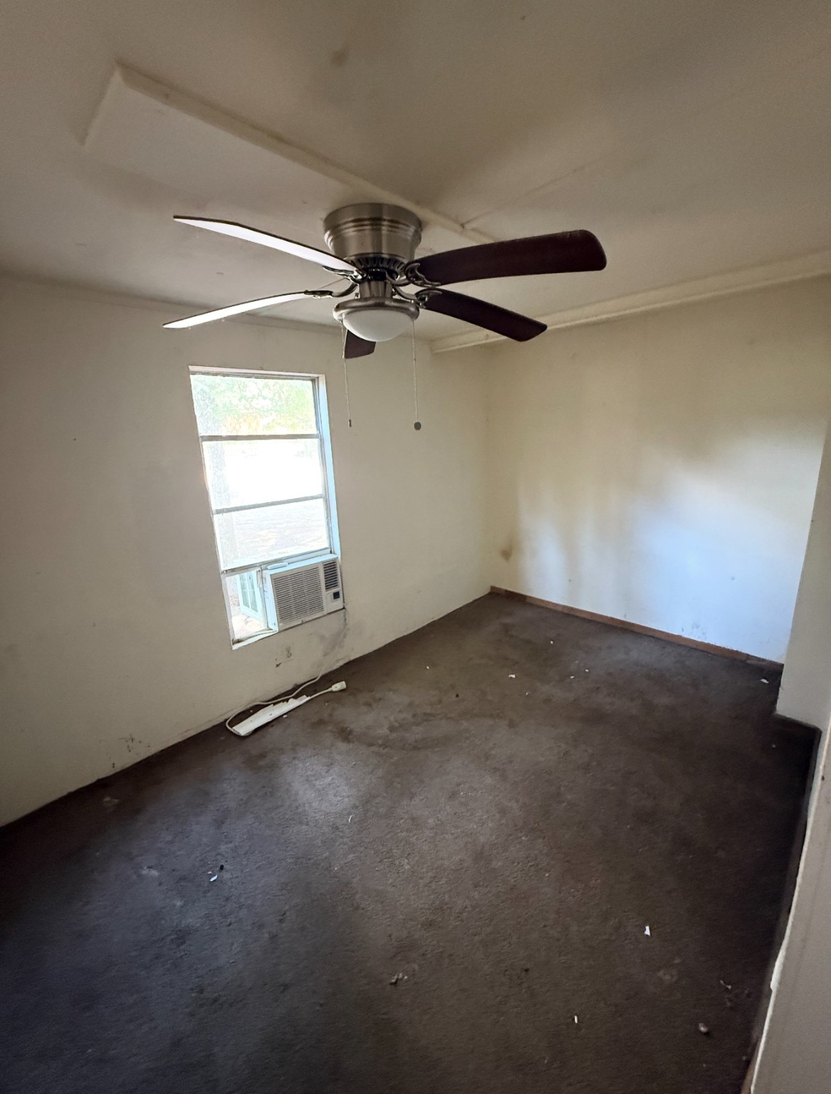 1059 Cardinal Lane Trinity, TX 75862 - Photo 2 of 7 an empty room with windows and fan