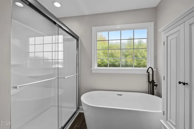 a white bath tub sitting next to a window