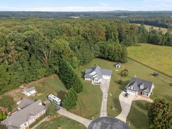 an aerial view of a house with a yard