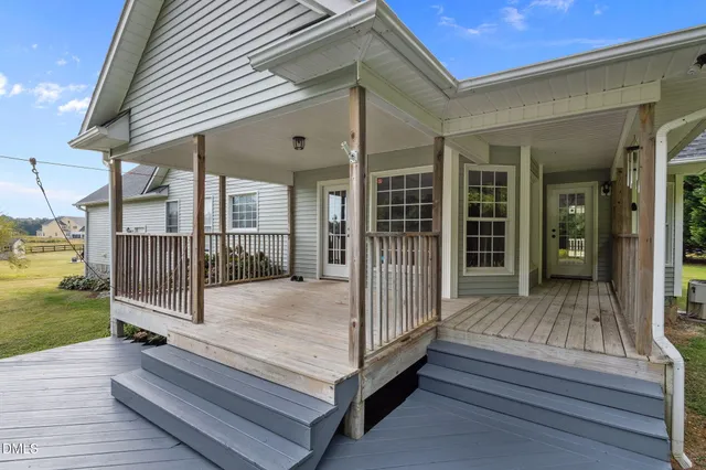 a view of backyard with swimming pool and porch