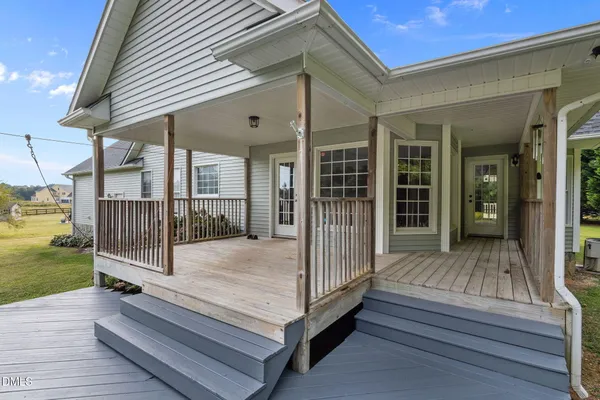 a view of backyard with swimming pool and porch