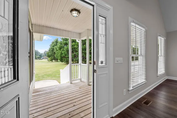 a view of a balcony with wooden floor