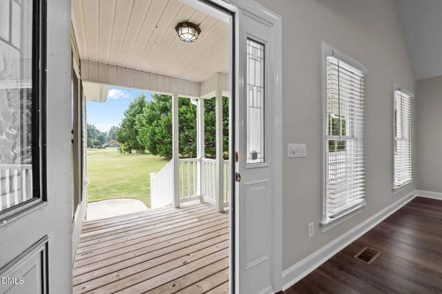 a view of a balcony with wooden floor