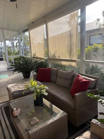 a living room with furniture and a floor to ceiling window