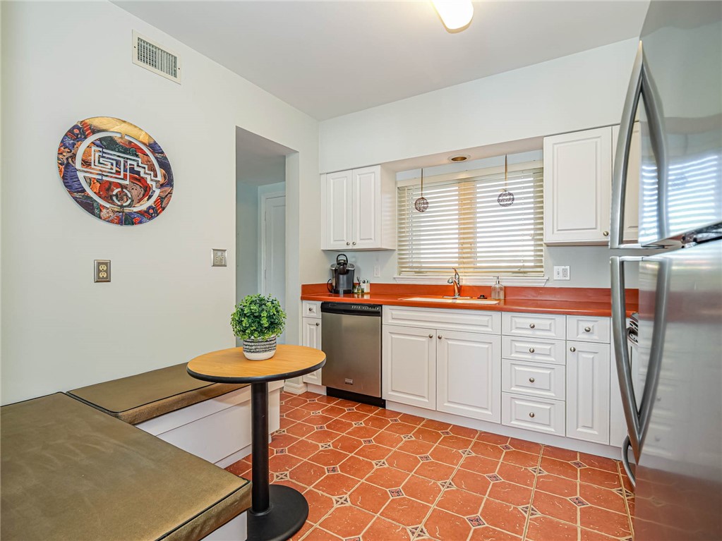 5010 Harmony Circle, Unit 206 Vero Beach, FL 32967 - Photo 1 of 13 a kitchen with stainless steel appliances a stove a sink and a refrigerator