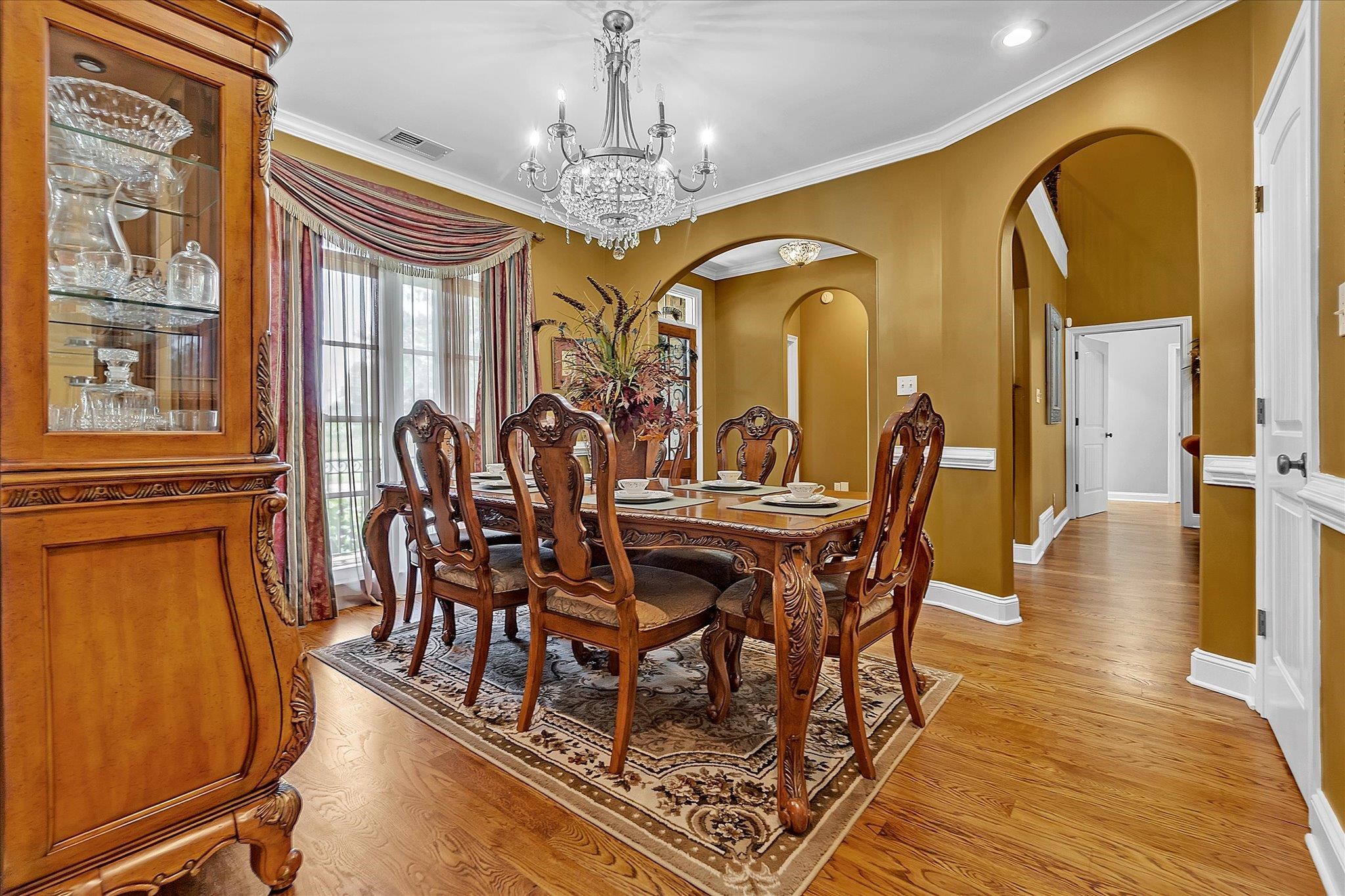 7284 Bucknell Road Millington, TN 38053 - Photo 6 of 35 Hardwood flooring, arched doorways, crown molding, a crystal chandelier, and large windows