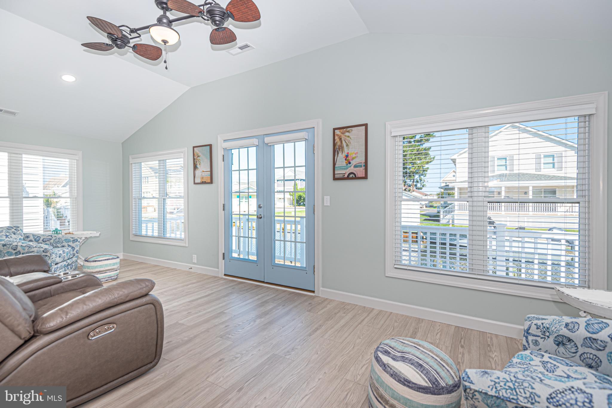 138 Old Wharf Road Ocean City, MD 21842 - Photo 5 of 33 a living room with furniture and a floor to ceiling windows