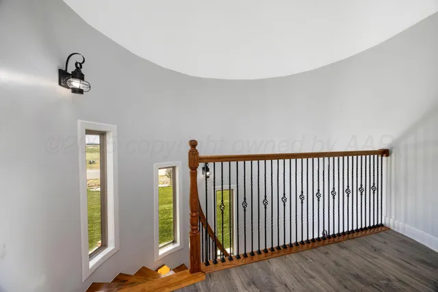 a view of a room with wooden floor staircase and windows