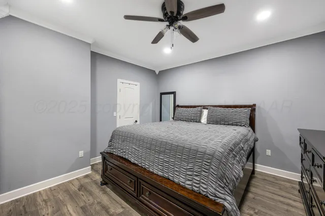 a bedroom with a bed and a ceiling fan