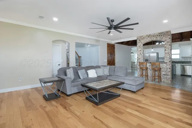a living room with furniture and wooden floor