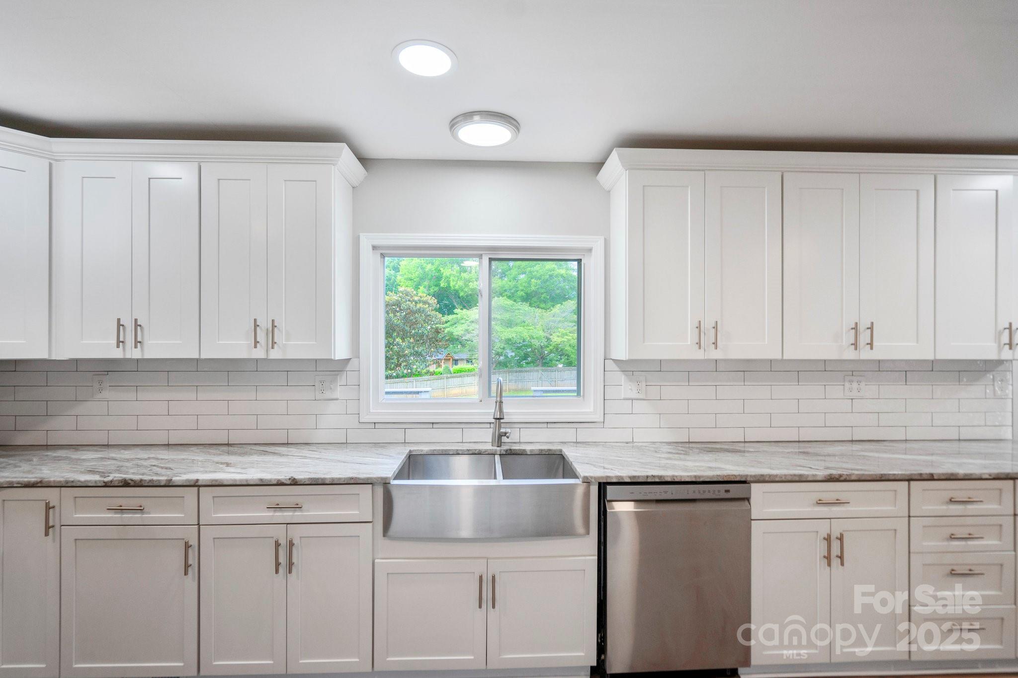 554 Isle Of Pines Road Mooresville, NC 28117 - Photo 14 of 44 a kitchen with granite countertop white cabinets and a window