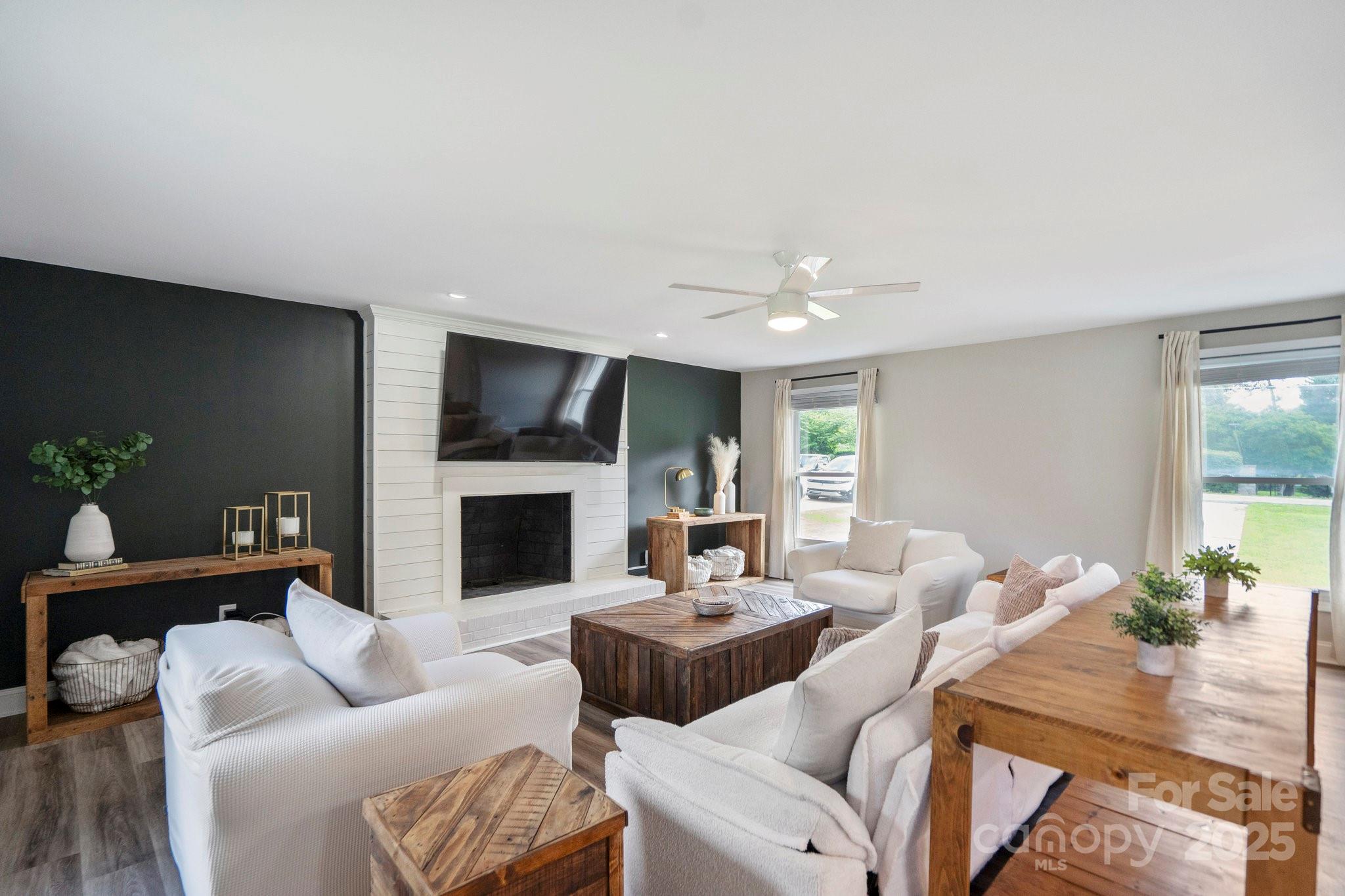 554 Isle Of Pines Road Mooresville, NC 28117 - Photo 21 of 44 a living room with furniture fireplace and a large window