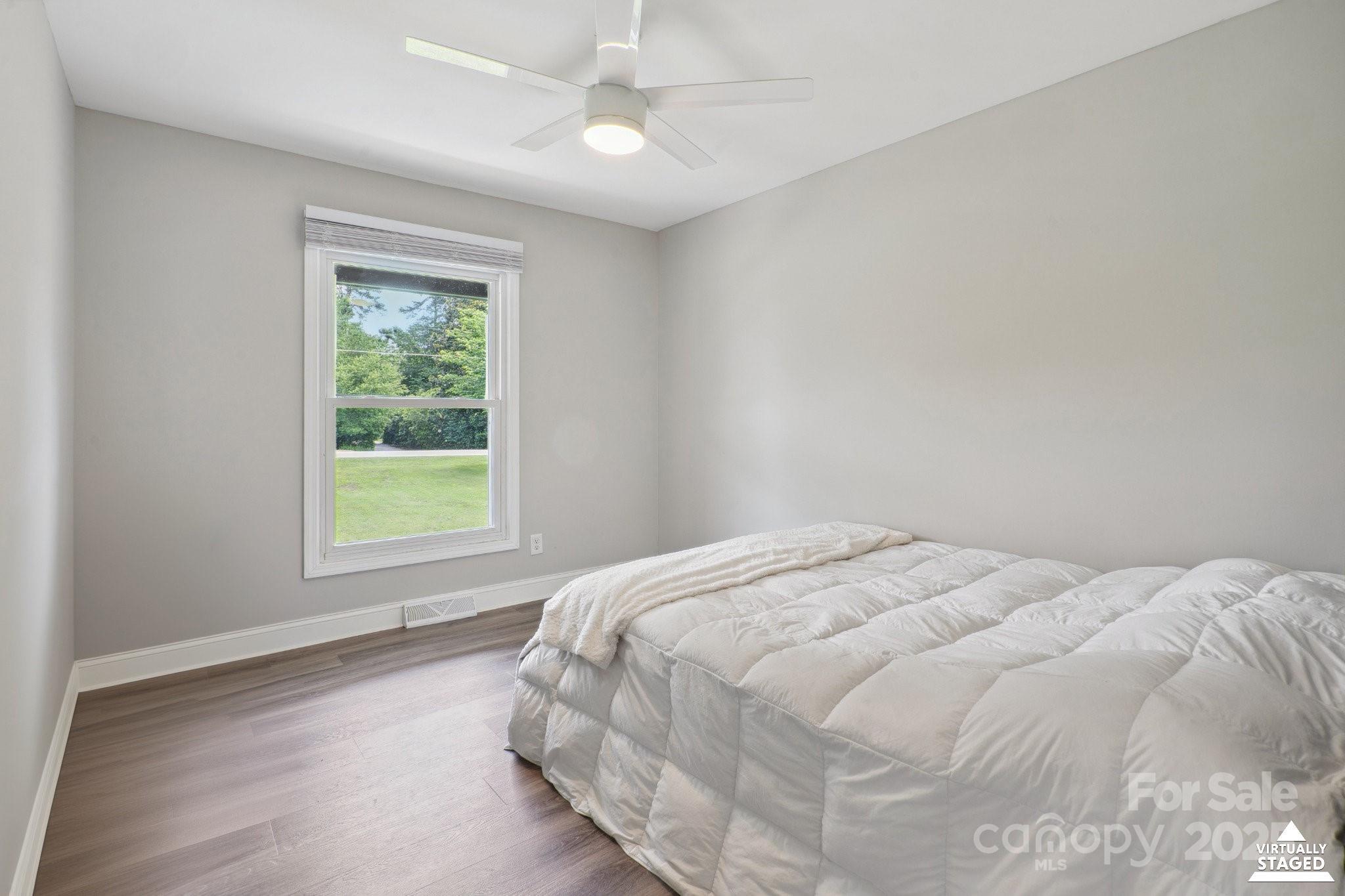 554 Isle Of Pines Road Mooresville, NC 28117 - Photo 25 of 44 a bed sitting in a bedroom next to a window