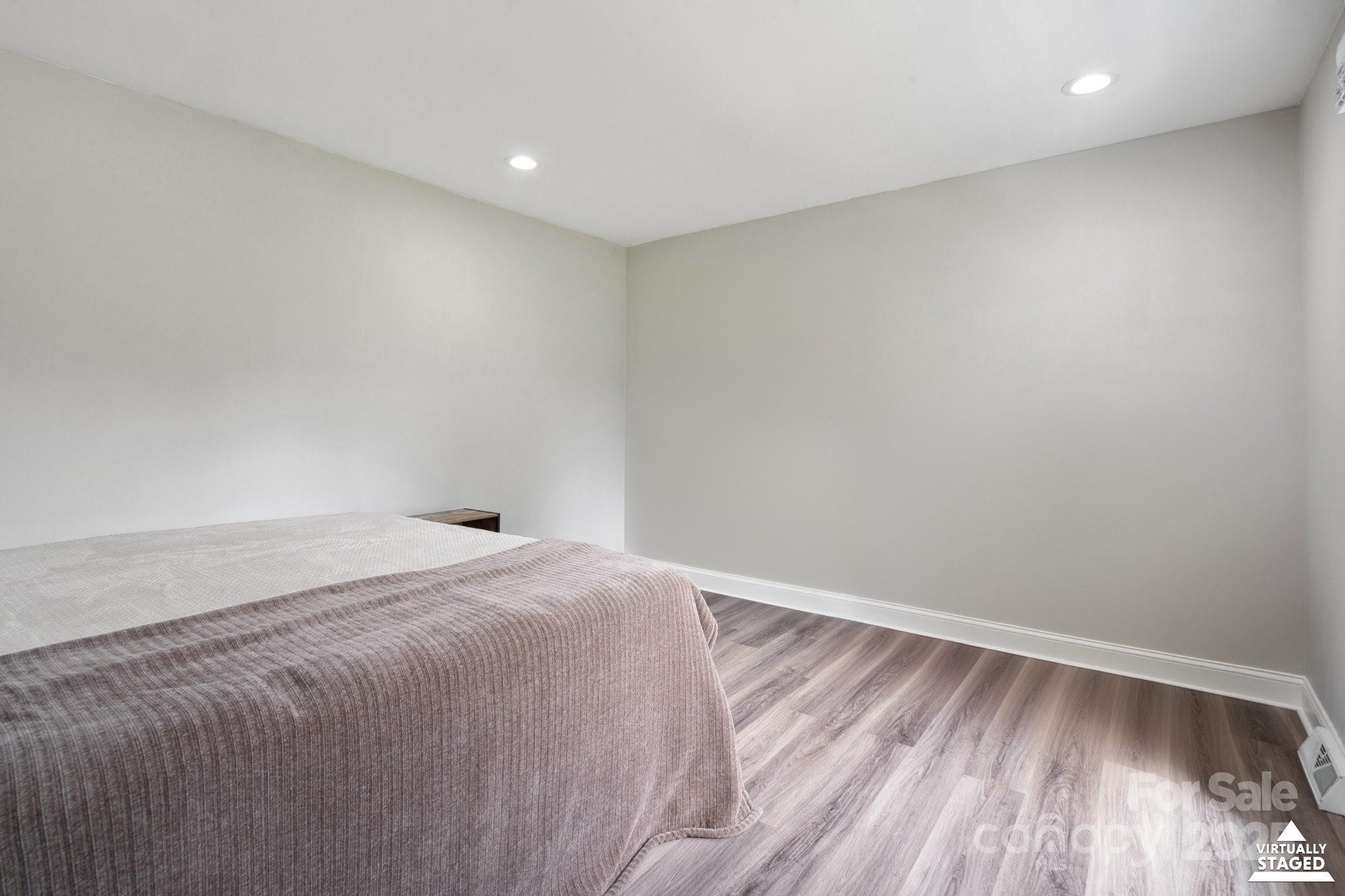 554 Isle Of Pines Road Mooresville, NC 28117 - Photo 26 of 44 a room with a bed and wooden floor