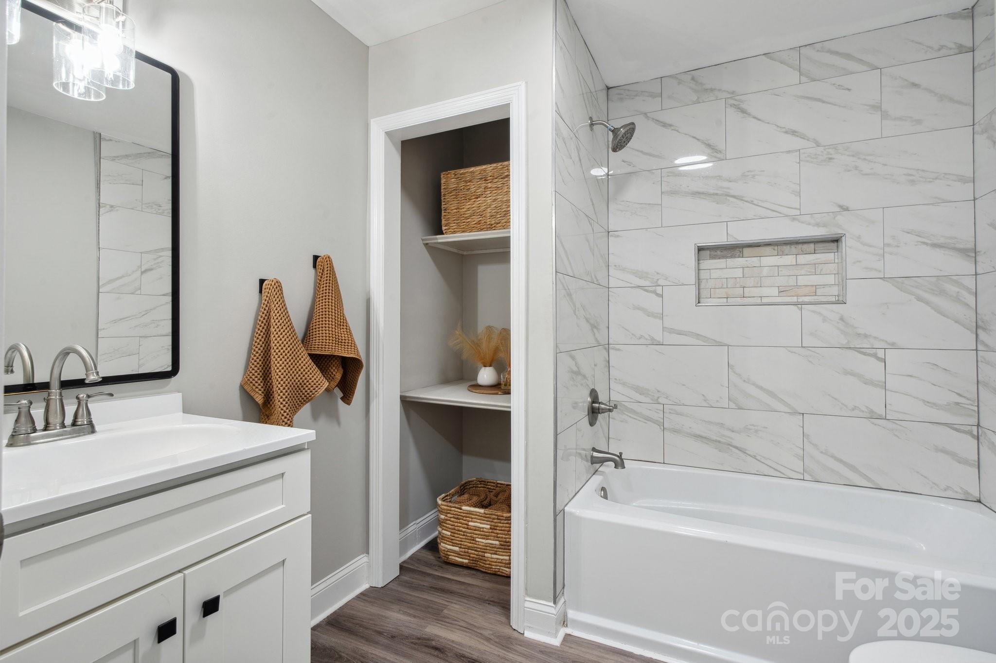554 Isle Of Pines Road Mooresville, NC 28117 - Photo 27 of 44 a bathroom with a tub sink vanity and mirror
