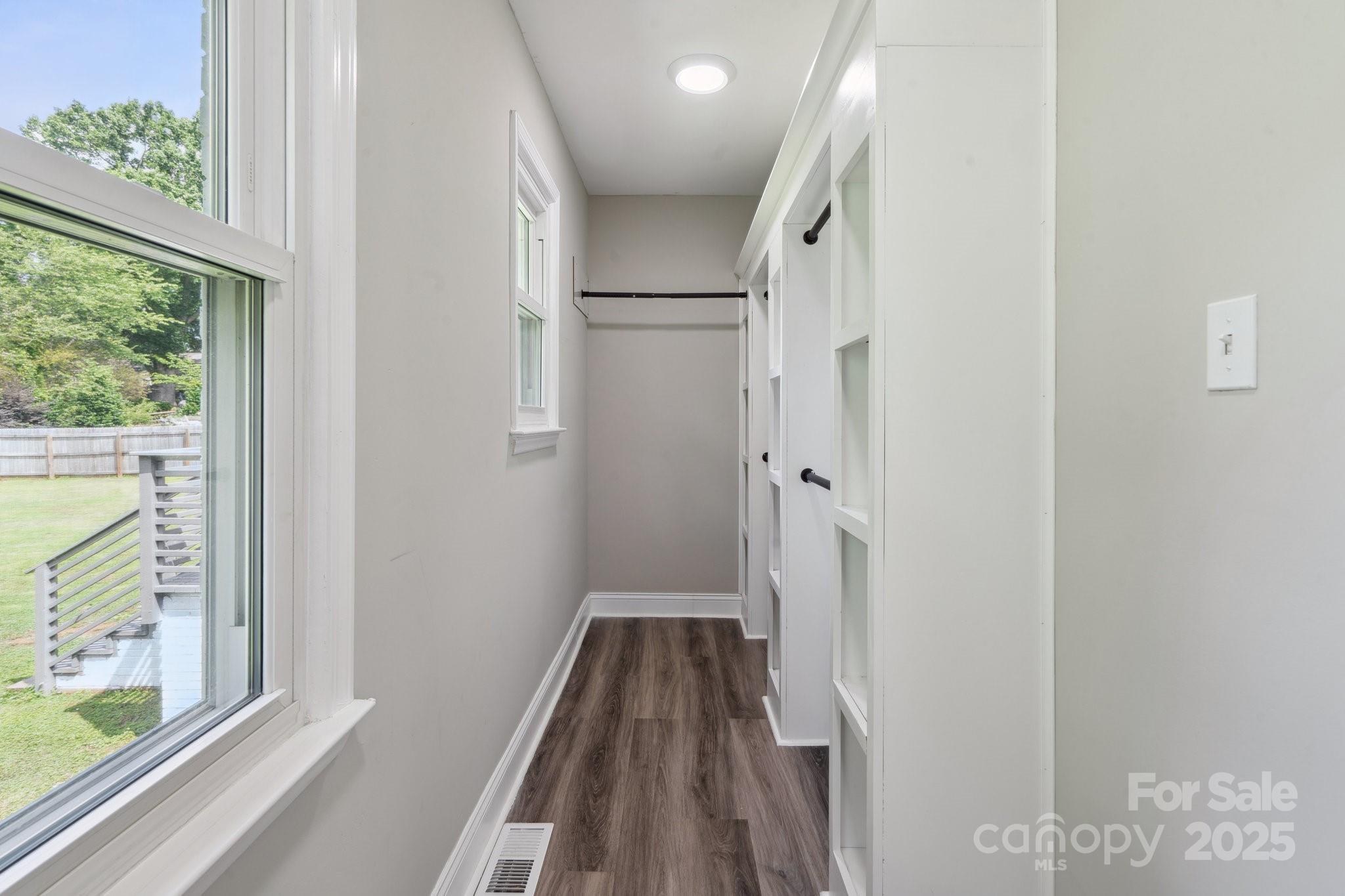 554 Isle Of Pines Road Mooresville, NC 28117 - Photo 28 of 44 a view of a hallway with wooden floor and staircase
