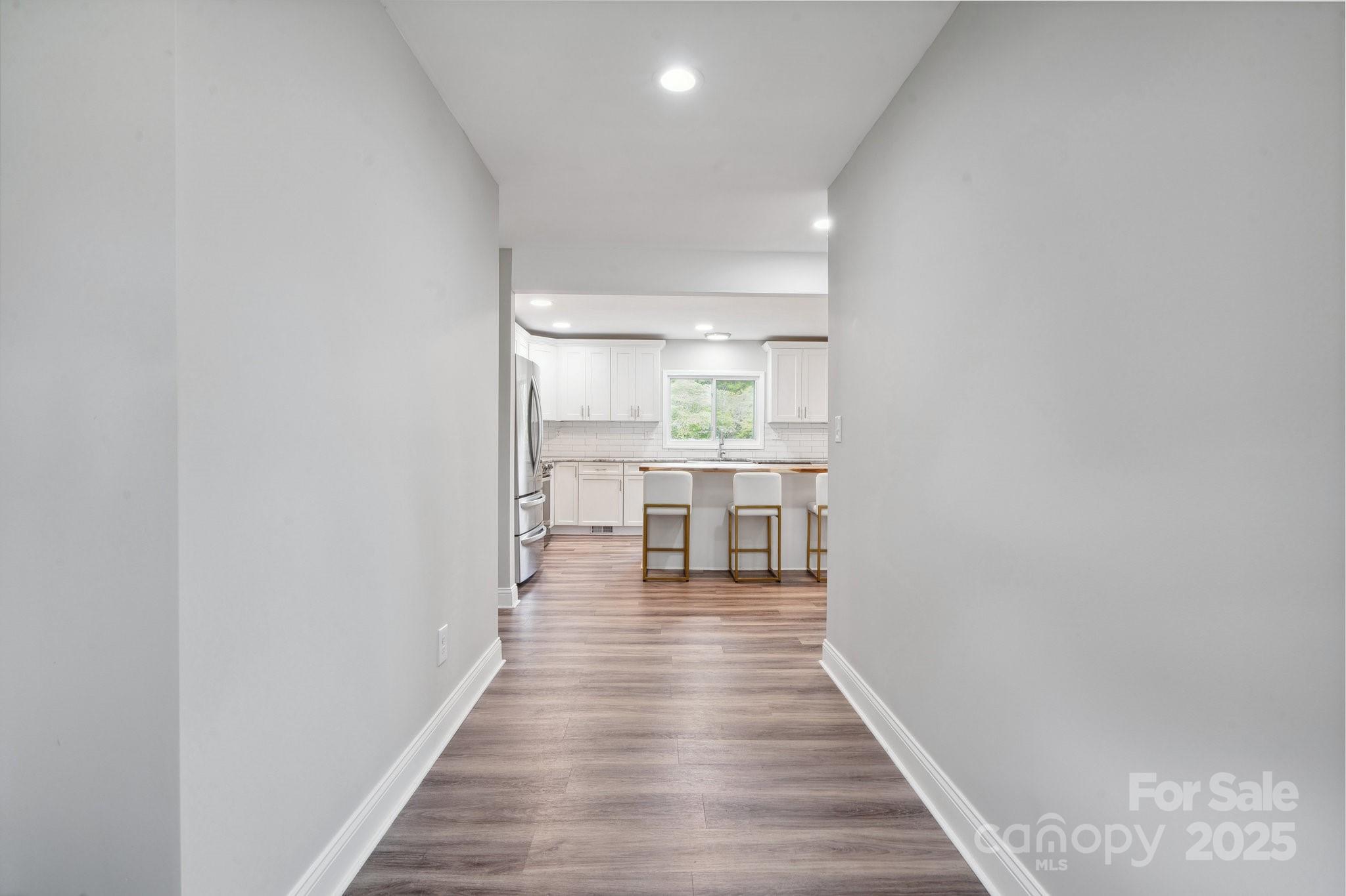 554 Isle Of Pines Road Mooresville, NC 28117 - Photo 9 of 44 a view of a kitchen from the hallway
