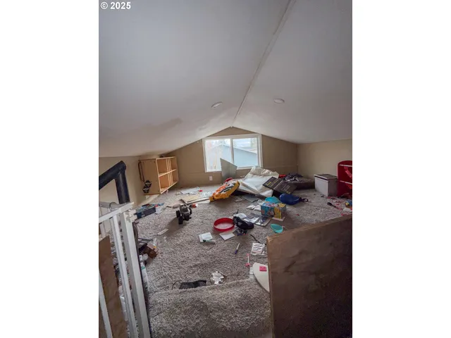 a bed sitting in a room next to a window