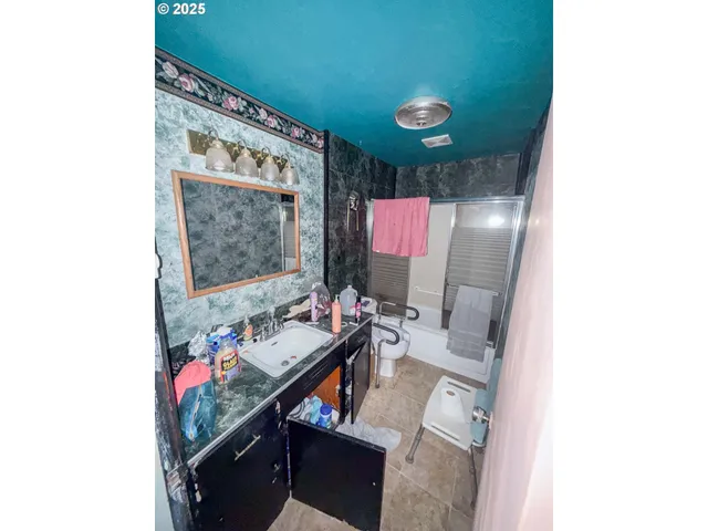 a bathroom with a sink vanity and a mirror