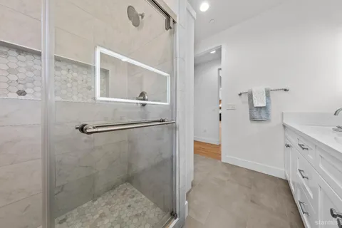 a bathroom with a shower and mirror