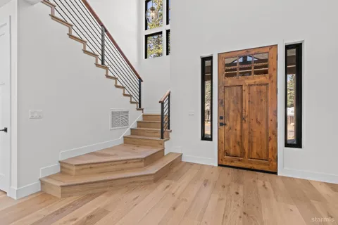 a view of entryway and hall with wooden floor