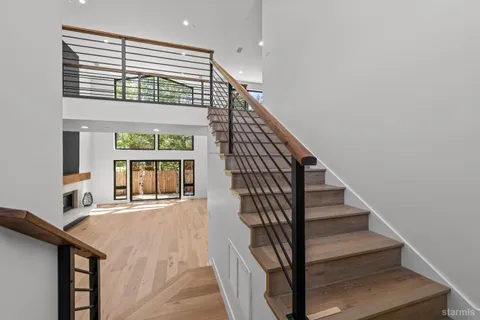 a view of entryway and hall with wooden floor
