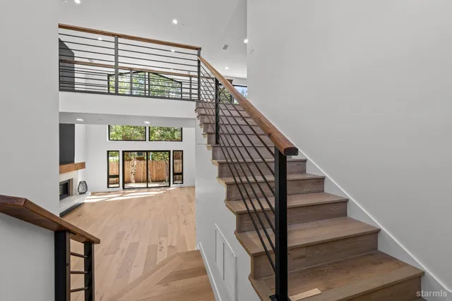 a view of entryway and hall with wooden floor