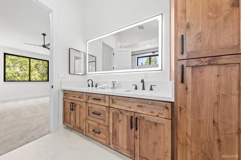 a spacious bathroom with double sink and a mirror