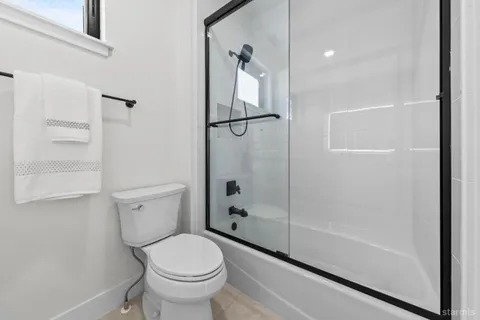 a bathroom with a toilet and a shower